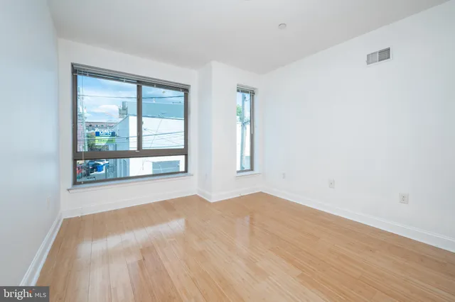 a view of a room with wooden floor