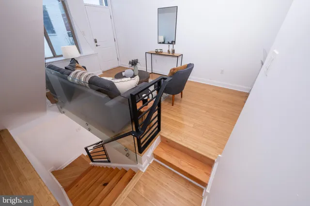 a living room with furniture and a view of kitchen