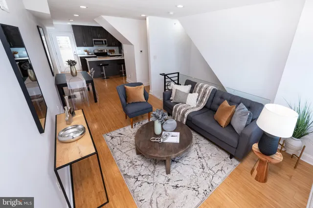 a living room with furniture kitchen view and a table