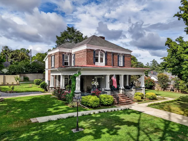 a front view of a house with a yard table and chairs