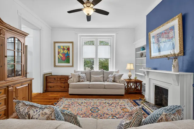 a living room with furniture fireplace and window
