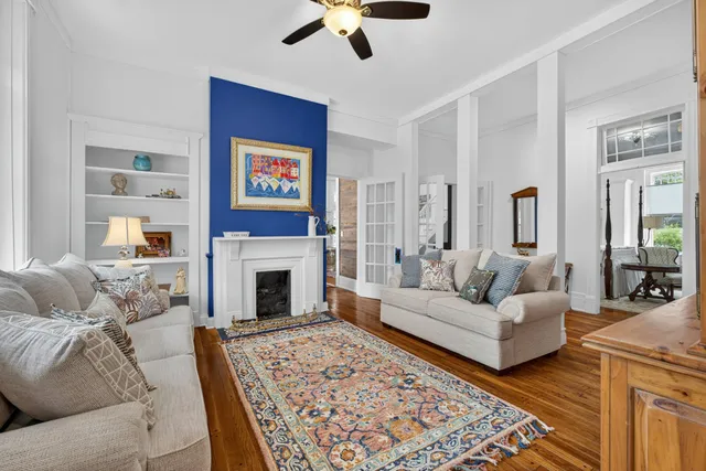 a living room with furniture a fireplace and a window