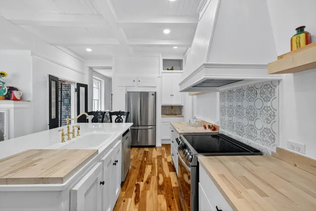 a dining room with furniture water view and large windows