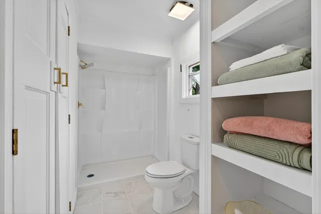 a view of an entryway with wooden floor and mirror