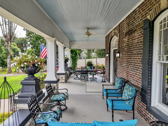 a view of a house with a yard porch and sitting area