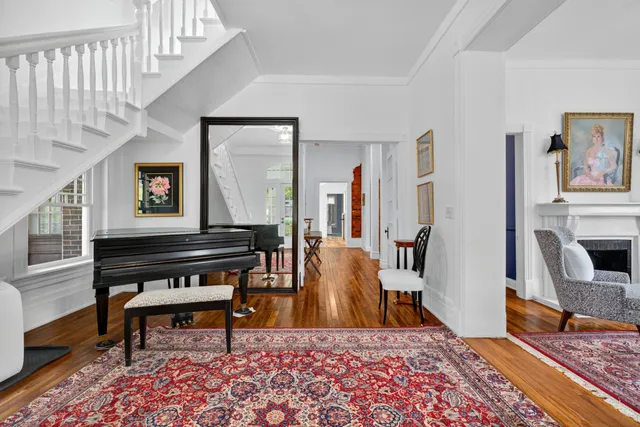 a living room with furniture a chandelier and a fireplace