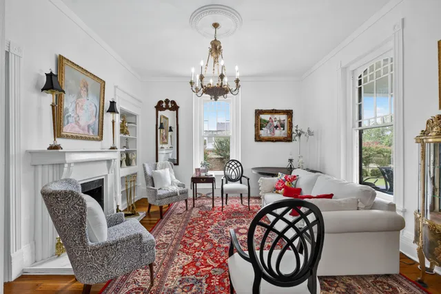 a living room with furniture and a chandelier