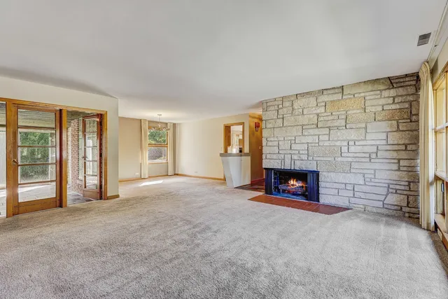 a view of empty room with a fireplace