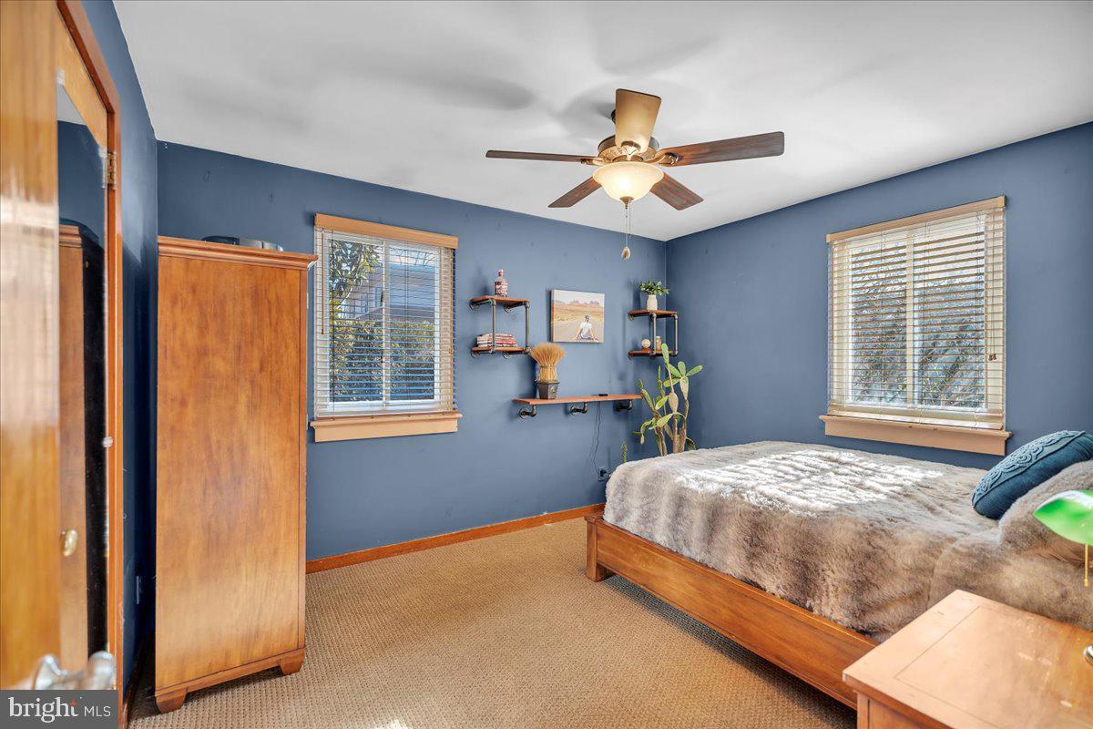 68 Riverside Avenue Roebling, NJ 08554 - Photo 11 of 33 a bedroom with a bed and a chandelier