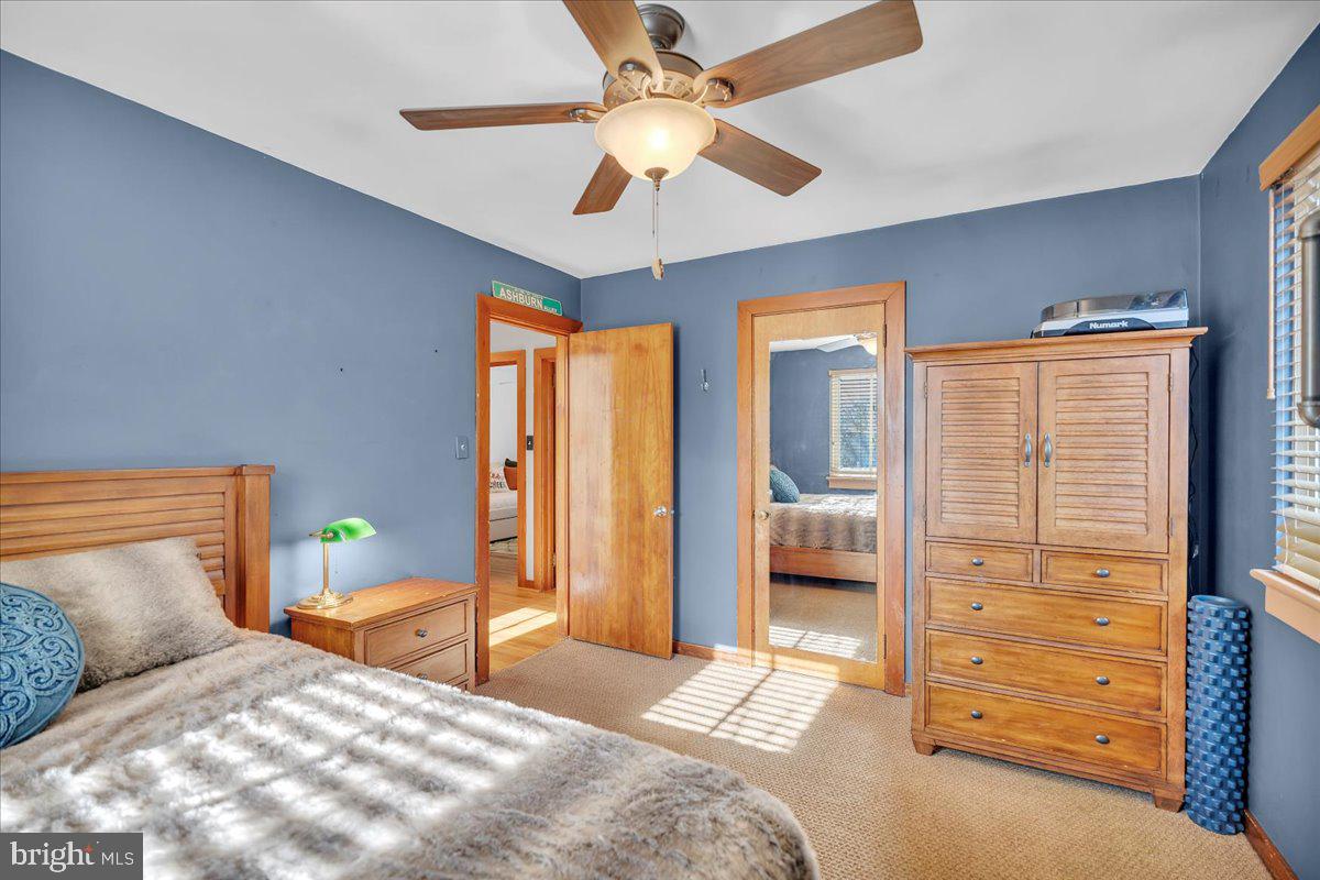 68 Riverside Avenue Roebling, NJ 08554 - Photo 10 of 33 a bedroom with a bed and a chandelier