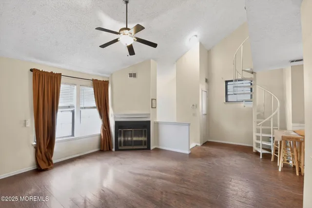 a view of livingroom with hardwood floor and ceiling fan