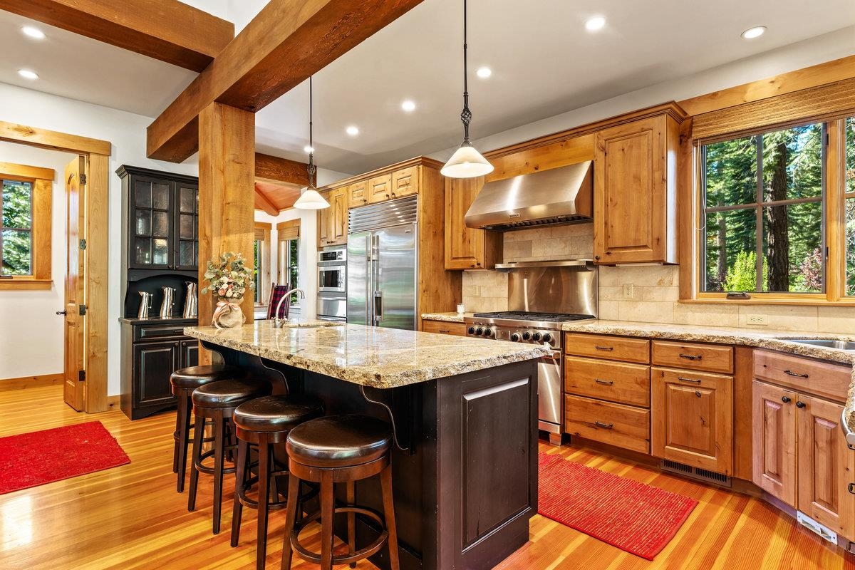 604 Ej Brickell Truckee, CA 96161 - Photo 9 of 21 a kitchen with kitchen island granite countertop a table chairs sink and wooden floor