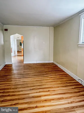 a view of a room with wooden floor