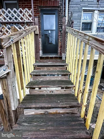a view of entryway with wooden floor and stairs