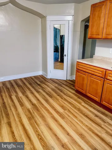a view of a room with wooden floor and cabinet