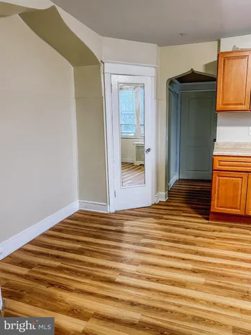 a view of a room with wooden floor and bathroom