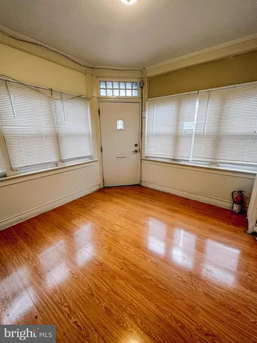 a view of a room with wooden floor and windows