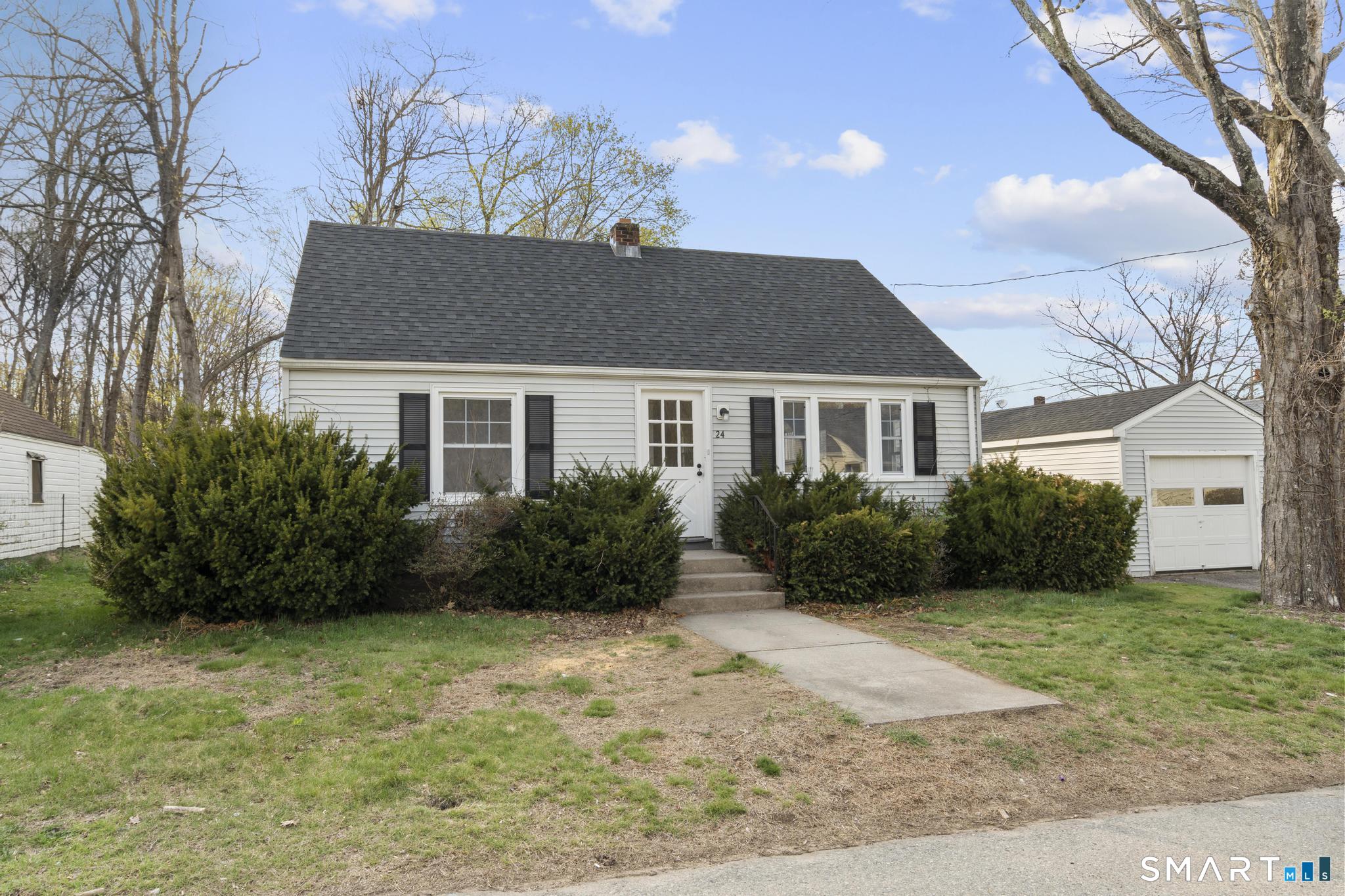 a front view of a house with a garden