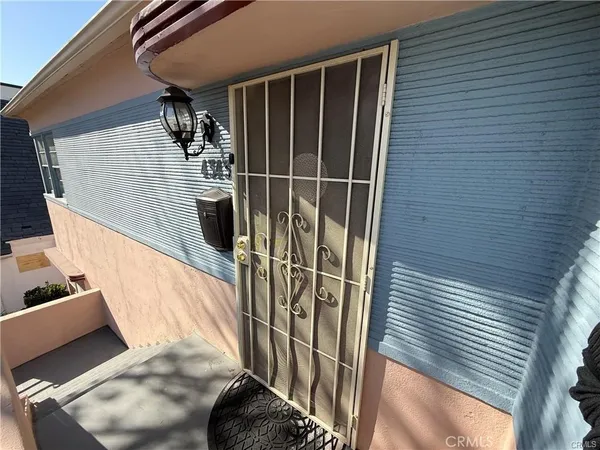 a kitchen with a refrigerator a sink and wooden floor