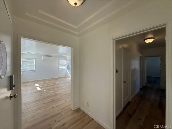 a view of empty room with wooden floor