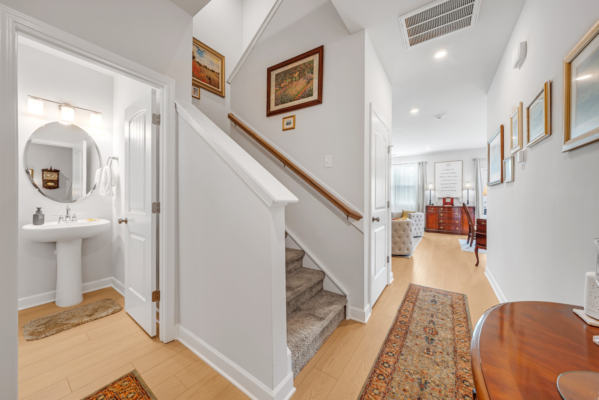127 Millbrook Dr Spring Hill Spring Hill, TN 37174 - Photo 6 of 33 a hallway with a couch and a dining table with wooden floor
