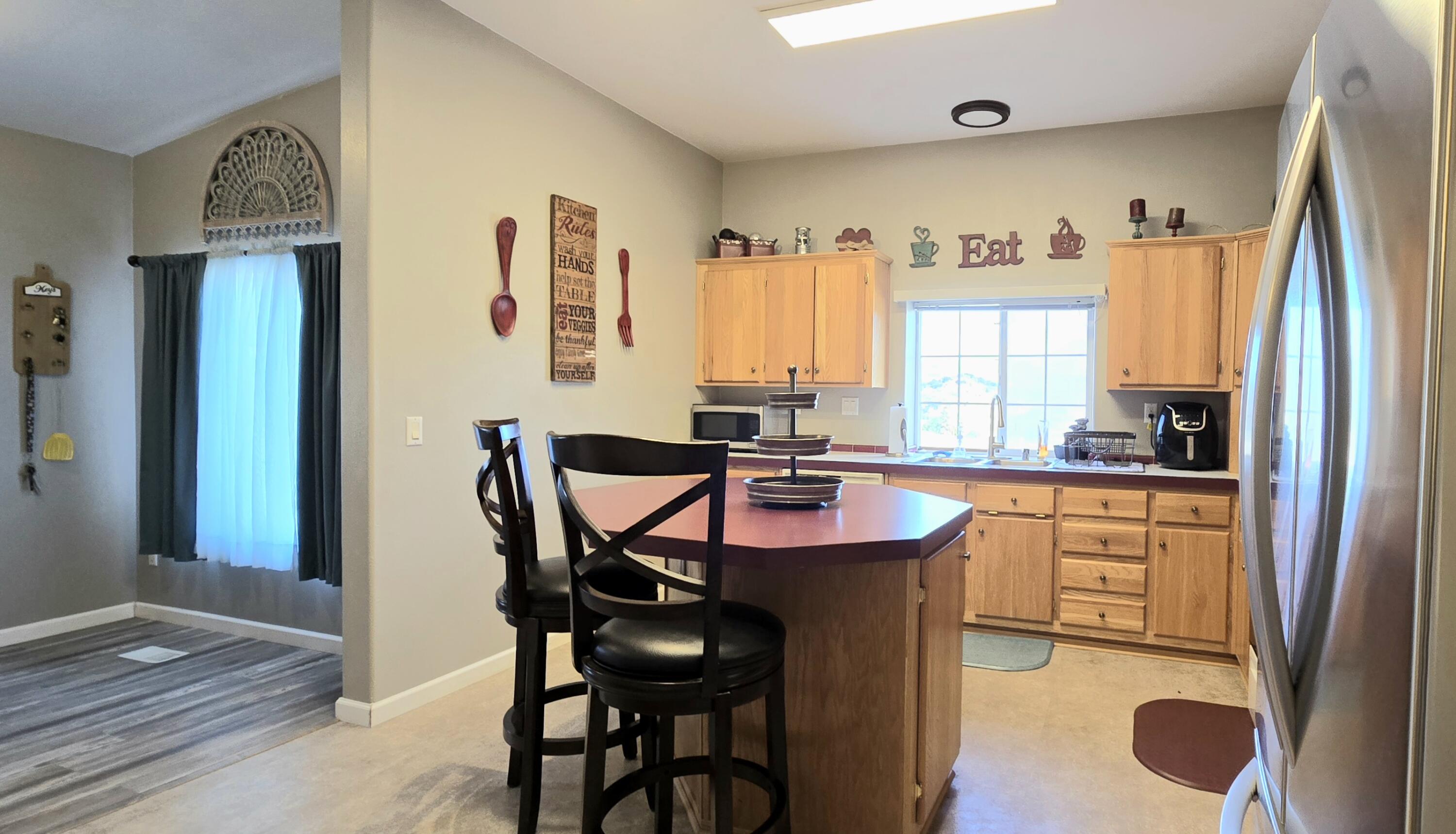 16617 Cottonwood Creek Road Hornbrook, CA 96044 - Photo 11 of 43 a kitchen with stainless steel appliances granite countertop a stove a refrigerator and a refrigerator with wooden floor