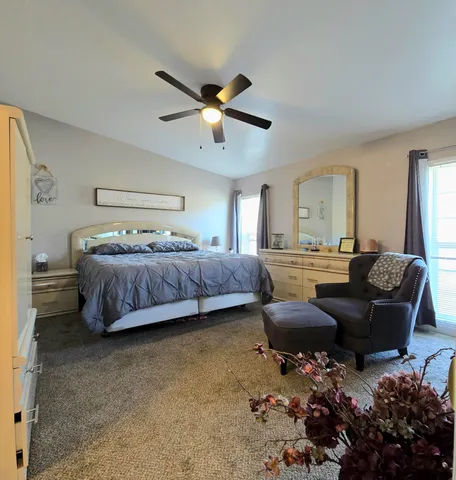 a bedroom with a bed dresser and a window