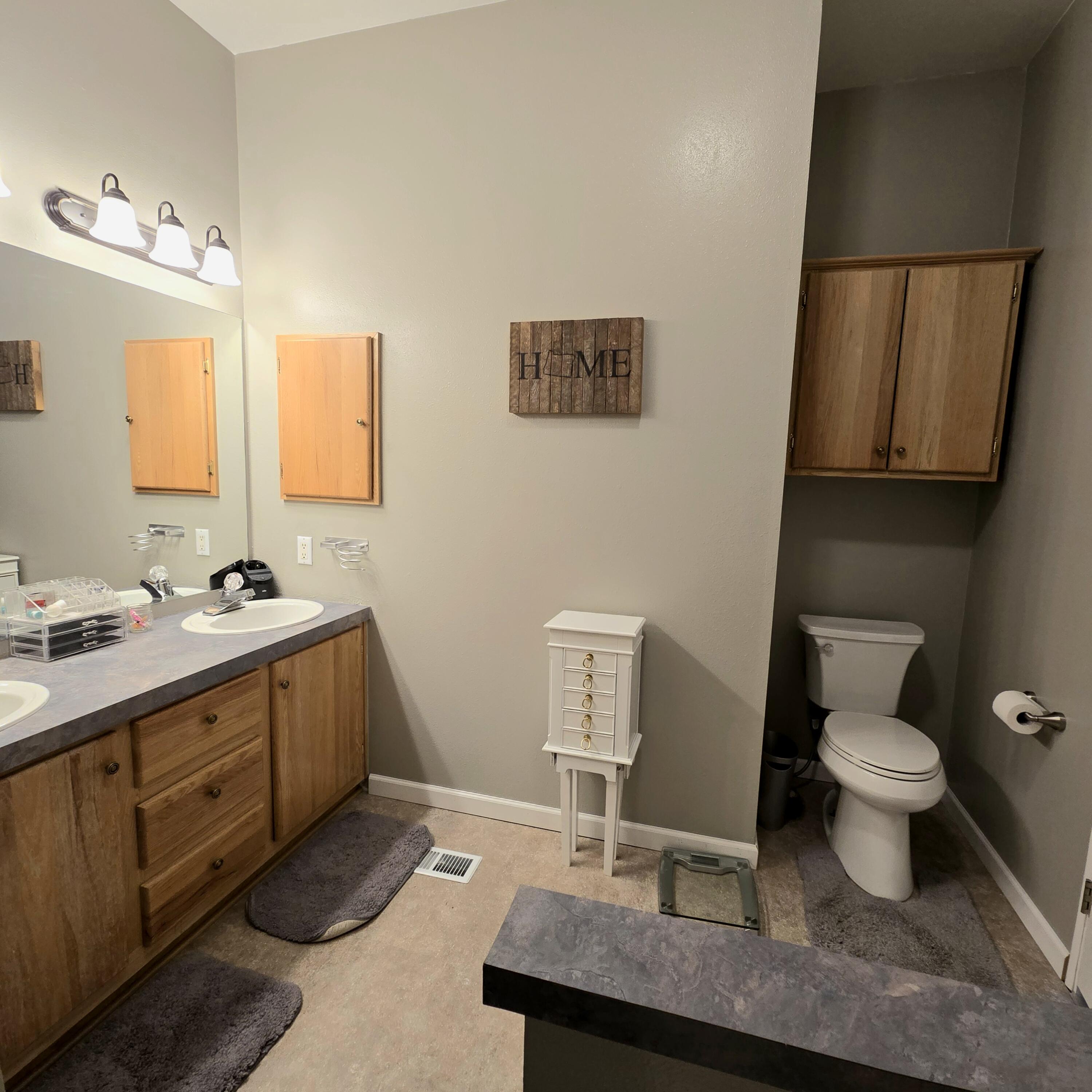 16617 Cottonwood Creek Road Hornbrook, CA 96044 - Photo 23 of 43 a bathroom with a granite countertop toilet sink and mirror