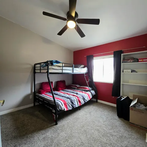 a bedroom with bed and window