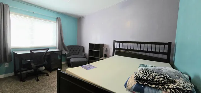 a bedroom with a bed and a table in it