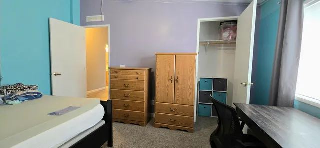 a bedroom with a bed and furniture