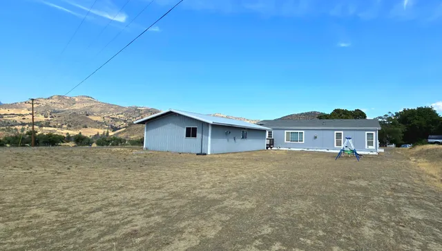 a big house with a big yard and large trees