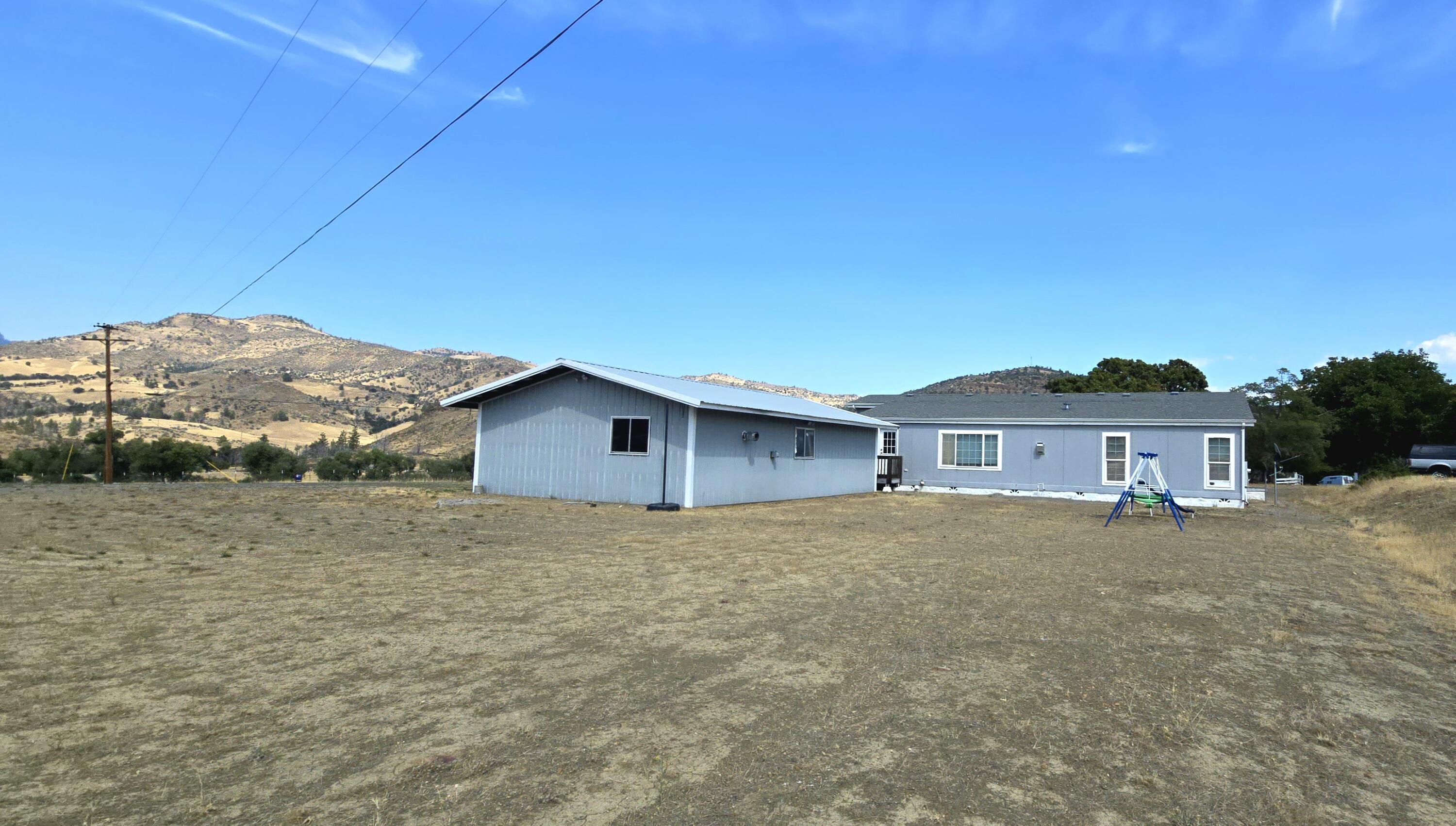 16617 Cottonwood Creek Road Hornbrook, CA 96044 - Photo 36 of 43 a big house with a big yard and large trees