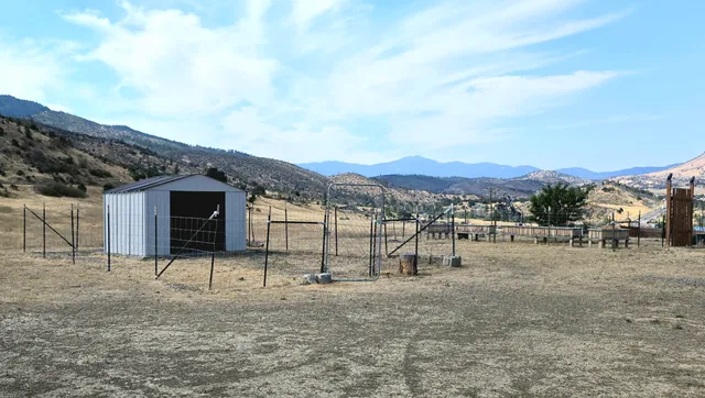 a view of a barn in the middle of a yard