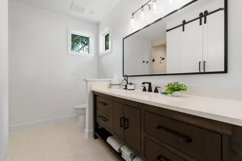 a bedroom with a bed chair and a window