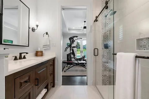 a bedroom with a bed couches and window