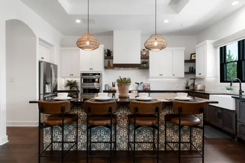 a dining room with stainless steel appliances kitchen island a table and chairs