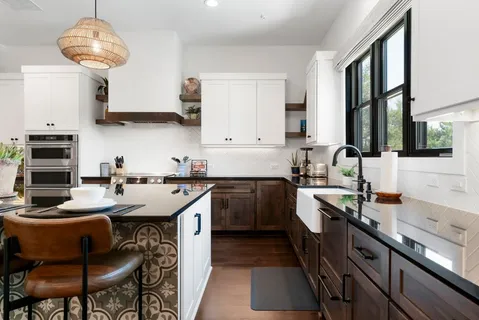 a kitchen with a sink and a stove top oven