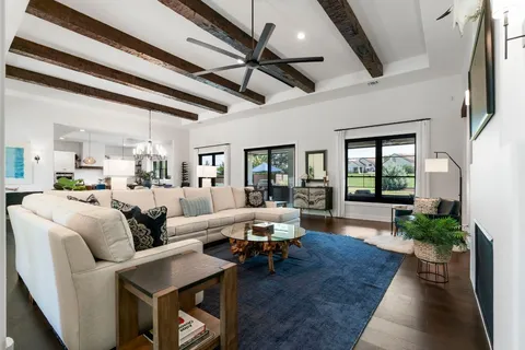 a dining hall with stainless steel appliances granite countertop a sink a stove and a wooden floors