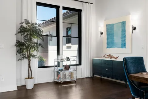 a view of a dining room with furniture and chandelier