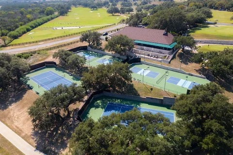 an aerial view of a houses with a swimming pool