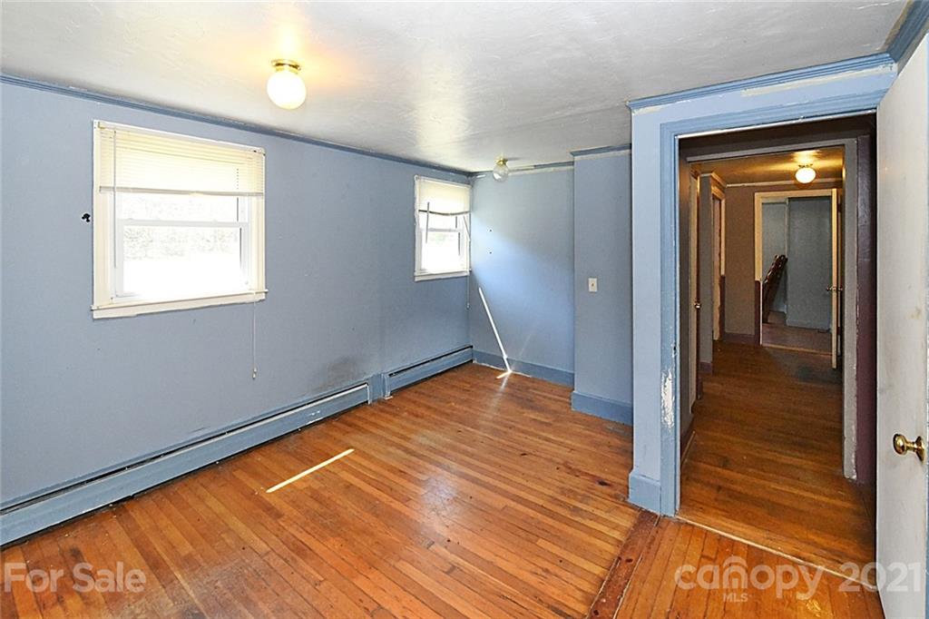 479 Joe Hampton Road Lansing, NC 28643 - Photo 12 of 44 a view of empty room with wooden floor