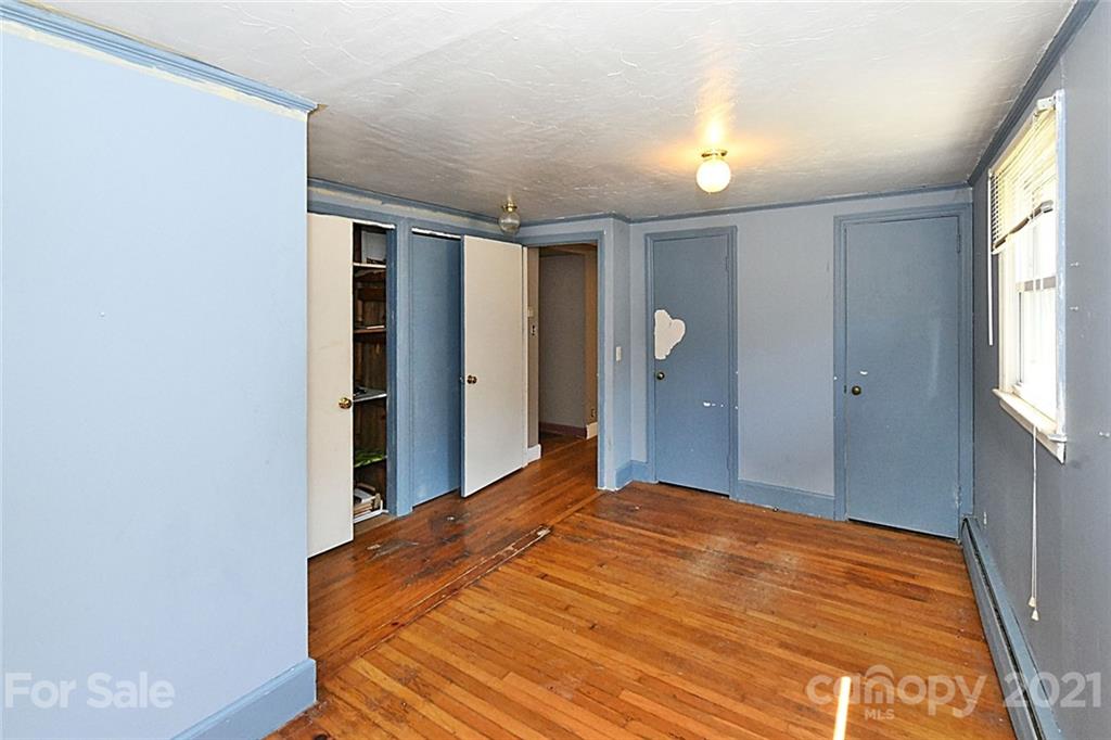 479 Joe Hampton Road Lansing, NC 28643 - Photo 13 of 44 a bedroom with a bed and a window