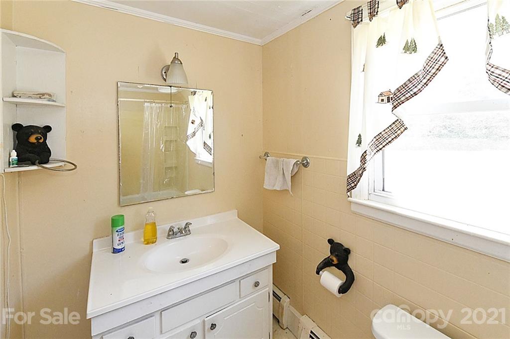 479 Joe Hampton Road Lansing, NC 28643 - Photo 14 of 44 a bathroom with a sink mirror and vanity