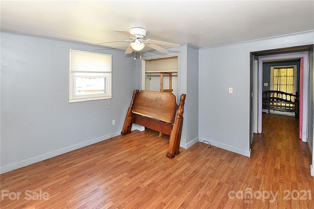 479 Joe Hampton Road Lansing, NC 28643 - Photo 17 of 44 a view of an empty room with wooden floor and a window