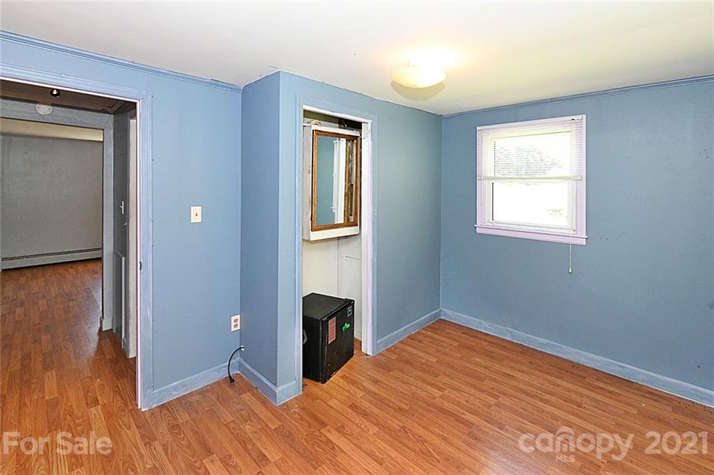 479 Joe Hampton Road Lansing, NC 28643 - Photo 20 of 44 a view of empty room with wooden floor and fan
