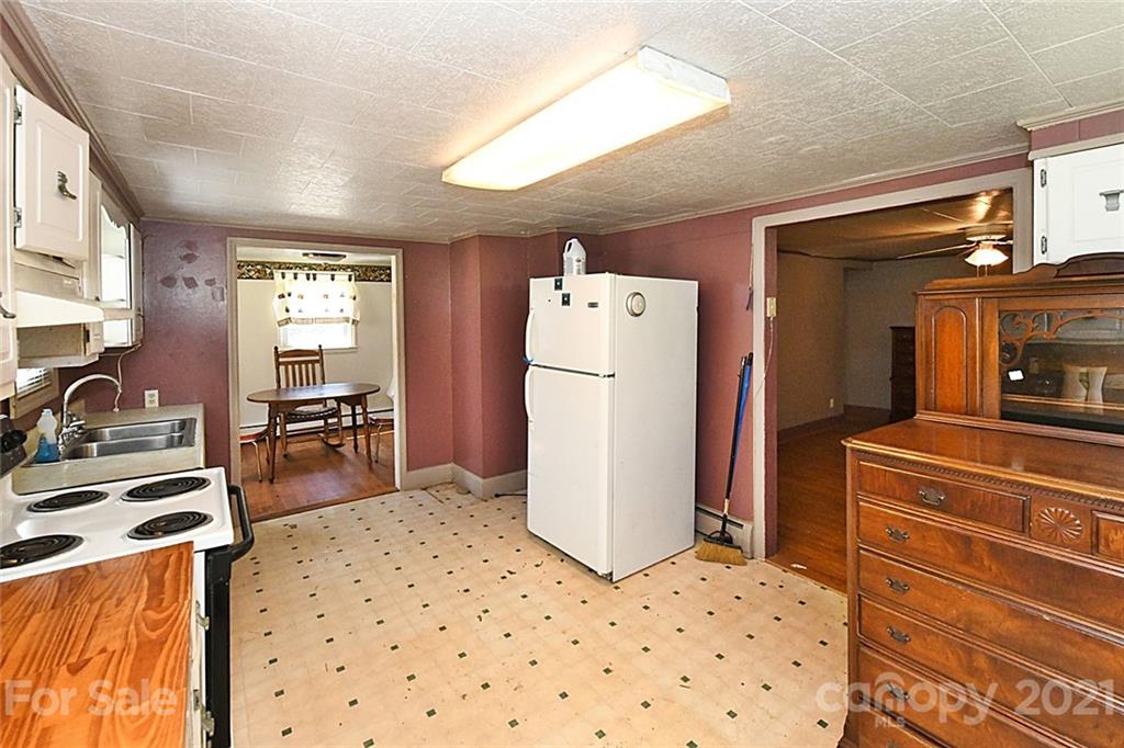 479 Joe Hampton Road Lansing, NC 28643 - Photo 8 of 44 a kitchen with a refrigerator and a stove