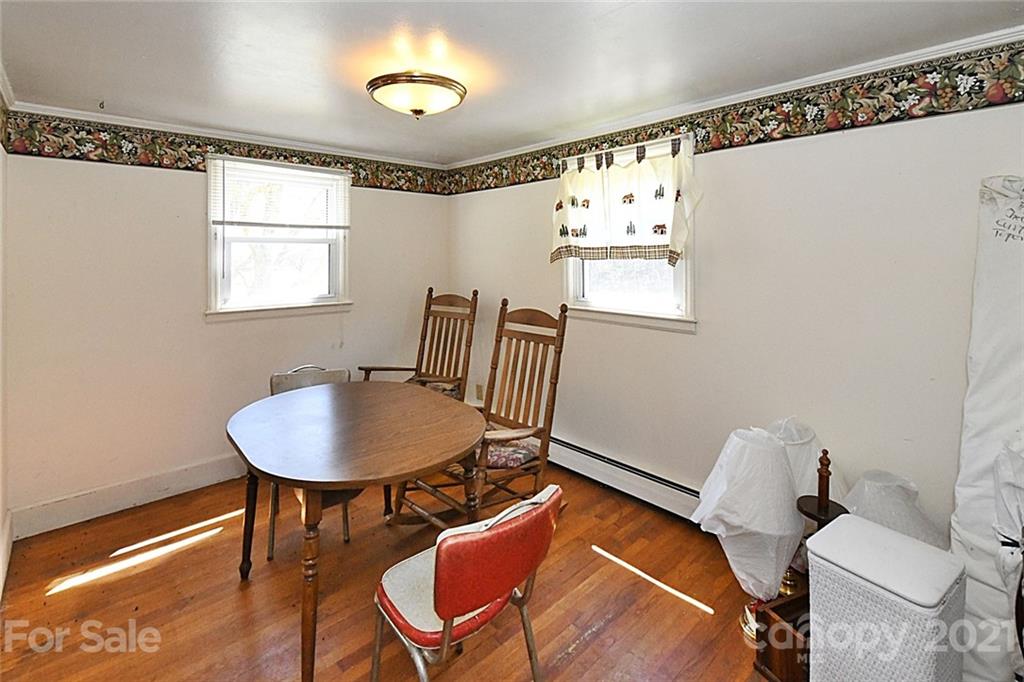 479 Joe Hampton Road Lansing, NC 28643 - Photo 10 of 44 a view of a dining room with furniture and wooden floor