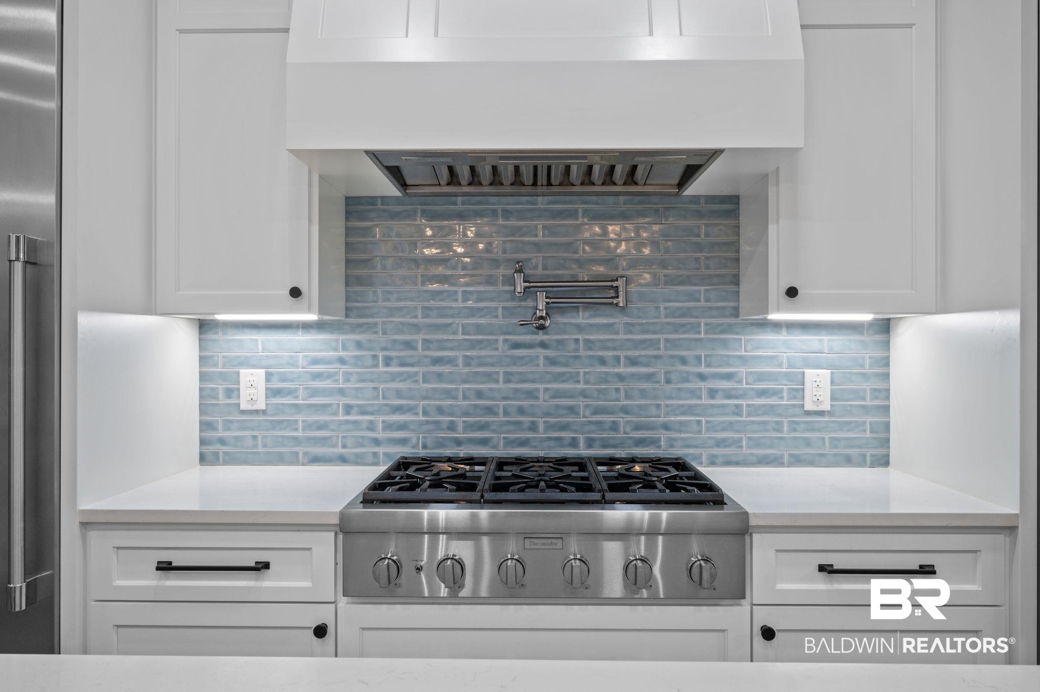 14591 Styx River Road Stapleton, AL 36578 - Photo 15 of 47 Kitchen with range hood, appliances with stainless steel finishes, white cabinets, and backsplash