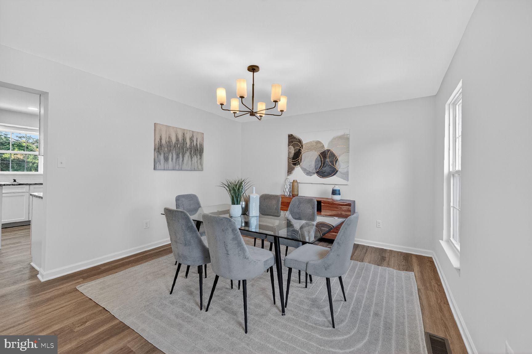 2339 Colts Brook Drive Reston, VA 20191 - Photo 11 of 51 a view of a dining room with furniture wooden floor and a chandelier
